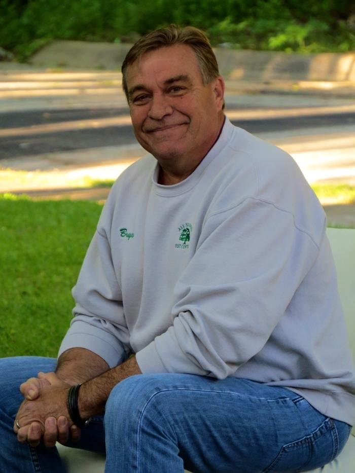 Bryan of All Seasons Pest Control smiling outdoors in a branded company sweatshirt